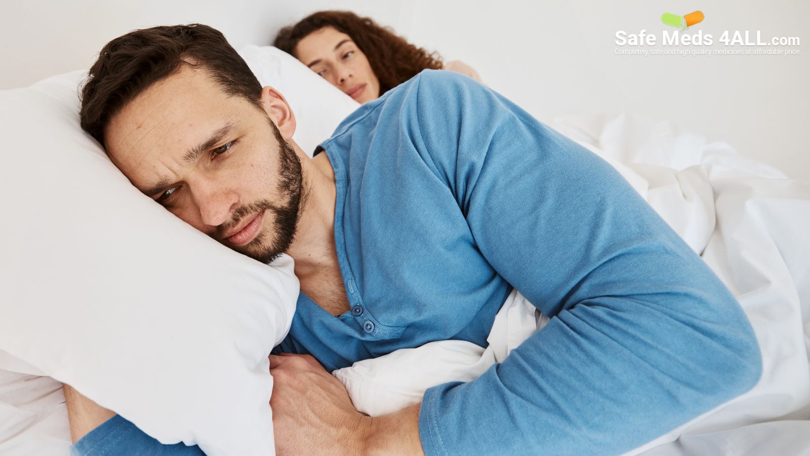 A couple lying on the bed.