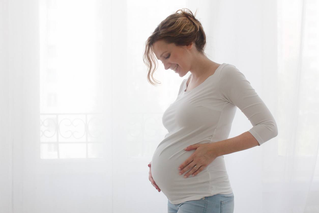 Pregnant lady looking at her baby bump