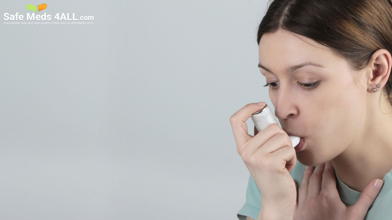 A woman inhaling medication to keep a check on Asthma.