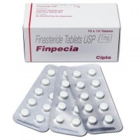 A box and three strips of generic Finasteride 1mg tablets